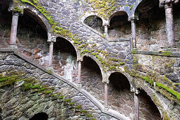 View of the spiral staircase of the Initiation Fountain in the garden Quinta da Regaleira, Sintra, Portugal