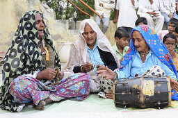 2015, Nandgoan / Nandagram, Vrindavan, Uttar Pradesh, India, Older women make music with billanga (drum) and karatals (cymbals) at a school event