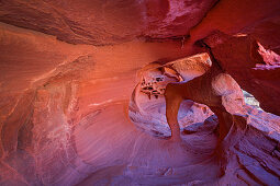 Windstone Arch cave with red rock formations in the Valley of Fire, USA