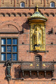 Detail of facade of Copenhagen City Hall (Kobenhavns Radhus), builded in 1905. Gold statue of Absalon bishop, Copenhagen, Zealand, Denmark