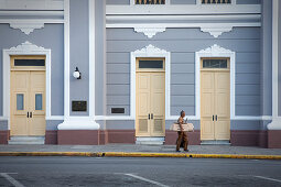 Man in front of house facade of Palacio de Gobierno in Cienfuegos, Cuba