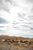 View of the ghost town of Bodie under a cloudy sky in the Eastern Sierra, California, USA.