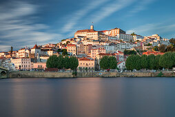 Coimbra skyline with Ponte Santa Clara bridge with Mondego river in the afternoon at sun, Portugal