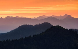 Mountain silhouettes of the Bavarian Prealps on Lake Walchensee in sunrise, from Jochberg