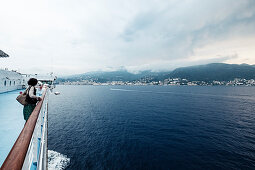 Tourist looks out from the ferry to Bastia, Corsica, France.