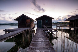 View of fishing huts in Lake Starnberg at sunset, Starnberg; Bavaria; Germany; Europe