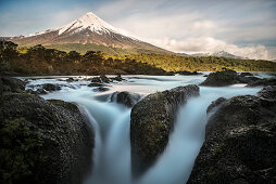View over somersault (waterfalls) of the Rio Petrohue to the Osorno volcano, Region de los Lagos, Chile, South America