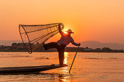 One-leg rower on Inle Lake at sunset on boat trip, Nyaung Shwe, Myanmar