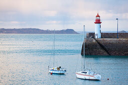 Morning mood at the Eruqy lighthouse - harbor entrance with boats. Brittany France