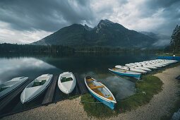 Rental boats on the banks of the Hintersee with a view of Schärtenspitze and Kleinkalter, Berchtesgadener Land, Bavaria, Germany
