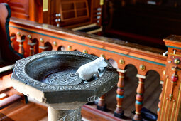 Baptismal font with toy mouse in the old church in Kopparberg, Örebro Province, Sweden
