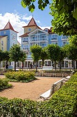 Park with benches in front of old villas on the beach promenade in Zinnowitz with tourists, Usedom, Mecklenburg-Western Pomerania, Germany