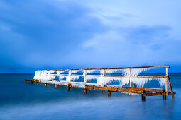 Bathing jetty with icicles at the blue hour, Baltic Sea, Heiligenhafen, Ostholstein, Schleswig-Holstein, Germany