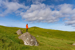 Hiker at Cape Kallur, northern tip of the island Kalsoy, Faroe Islands