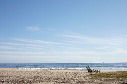 Man in beach chair overlooking Stearns Wharf in Santa Barbara, California, USA: