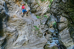 Woman commits Möllschlucht via ferrata, Möllschlucht, Glockner Group, Hohe Tauern, Hohe Tauern National Park, Carinthia, Austria