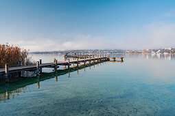 Morning view of the bathing jetty on Lake Starnberg on the bathing beach of Percha, Starnberg, Bavaria, Germany.