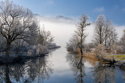Winter idyll at the Kochelsee spout of the Loisach, Bavaria, Germany.