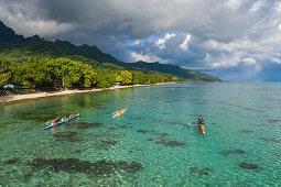 Aerial view of outrigger racing canoes in the Moorea Lagoon, Avamotu, Moorea, Windward Islands, French Polynesia, South Pacific