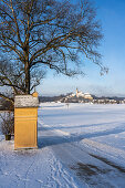 Andechs Monastery in a snowy winter landscape with a station path to the Friedrichskapelle, Andechs, Bavaria, Germany.