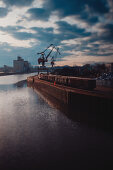 Port facility in Regenburg with a train and cranes in the background, Regensburg, Germany