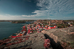 Coast and village Fjällbacka from Vetteberget mountain with crevice from above during day with sun and blue sky on the west coast in Sweden