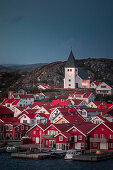 Red houses with a church in the village of Skärhamn on the archipelago island of Tjörn on the west coast of Sweden, in the evening