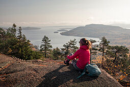 Frau blickt von Berg Skuleberget auf die Küste von Höga Kusten im Osten von Schweden\n