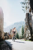 Road biking, woman riding a racing bike on the road