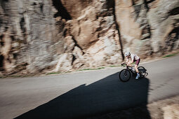 Road biking, woman riding a racing bike on the road