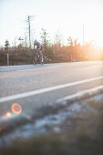 Road biking, woman riding a racing bike on the road