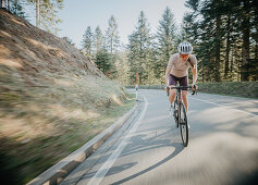 Road biking, woman riding a racing bike on the road