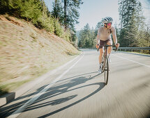 Road biking, woman riding a racing bike on the road