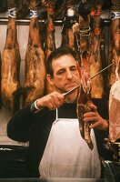 Butcher cutting "Jamon Serrano" (Serrano ham)