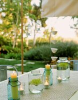 Table decoration of candles & flowers in preserving jars