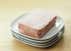 Frozen mince lying on a plate to thaw