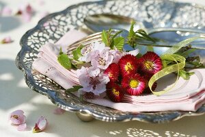 Bellis and peach blossom on a fabric napkin