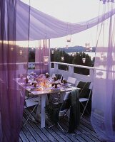 Table laid for special occasion out of doors at twilight