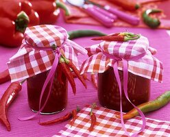 Paprika sugo in jars with checked fabric covers