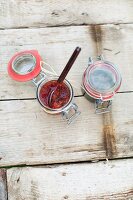 Jars of tomato chutney and herb sauce for a picnic