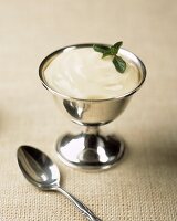 Vanilla Pudding in Silver Dish with Mint and a Spoon
