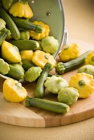 Assorted Baby Squash Spilling From a Colander; Patty Pan and Courgettes