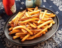 Large Plate of French Fries; Bottle of Ketchup