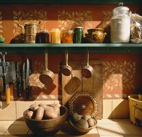 Preserving jars and potatoes on a kitchen shelf
