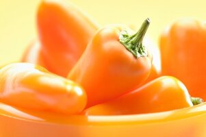 Orange peppers in a bowl (close-up)