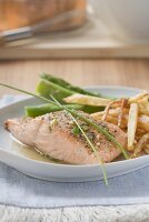 Salmon fillet with chips and green asparagus