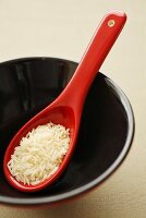 A spoonful of basmati rice in lacquer bowl