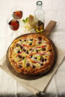 Sausage and Vegetable Pizza on Wooden Wheel with Wine