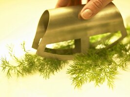 Chopping dill with a mezzaluna