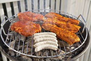 Sausages and meat on a barbecue